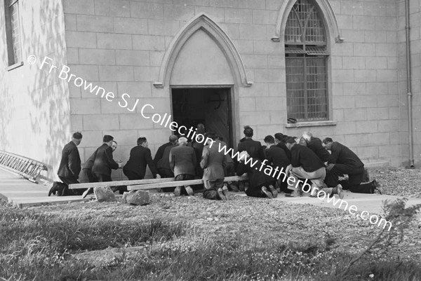 AFTER WOMENS CLOSING MEN KNEELING OUTSIDE CHURCH